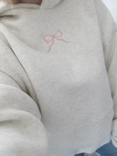 Women's bow embroidery hoodie in a loose fit.
